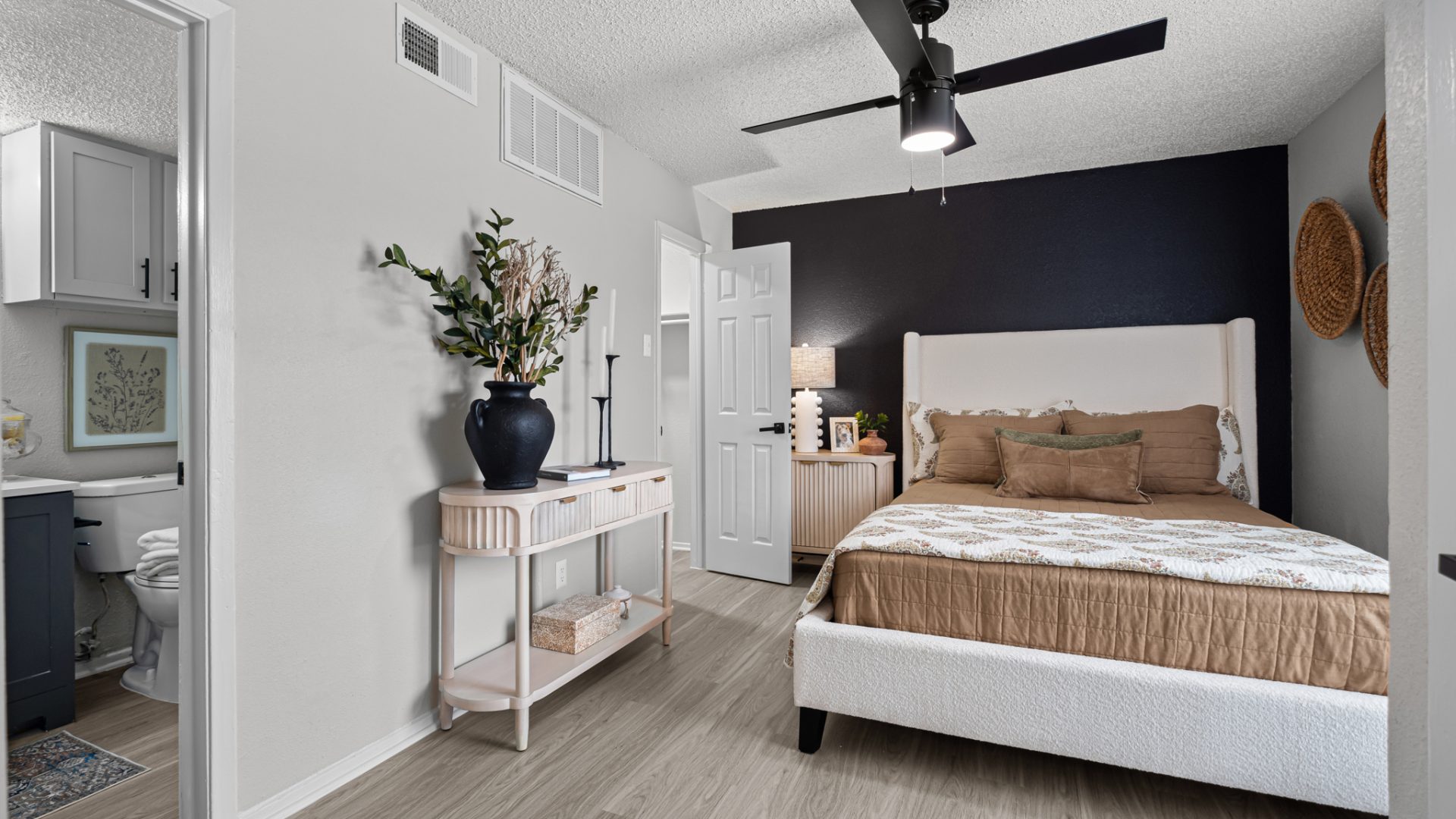 a bedroom with a ceiling fan and hardwood floors at The  Dahlia