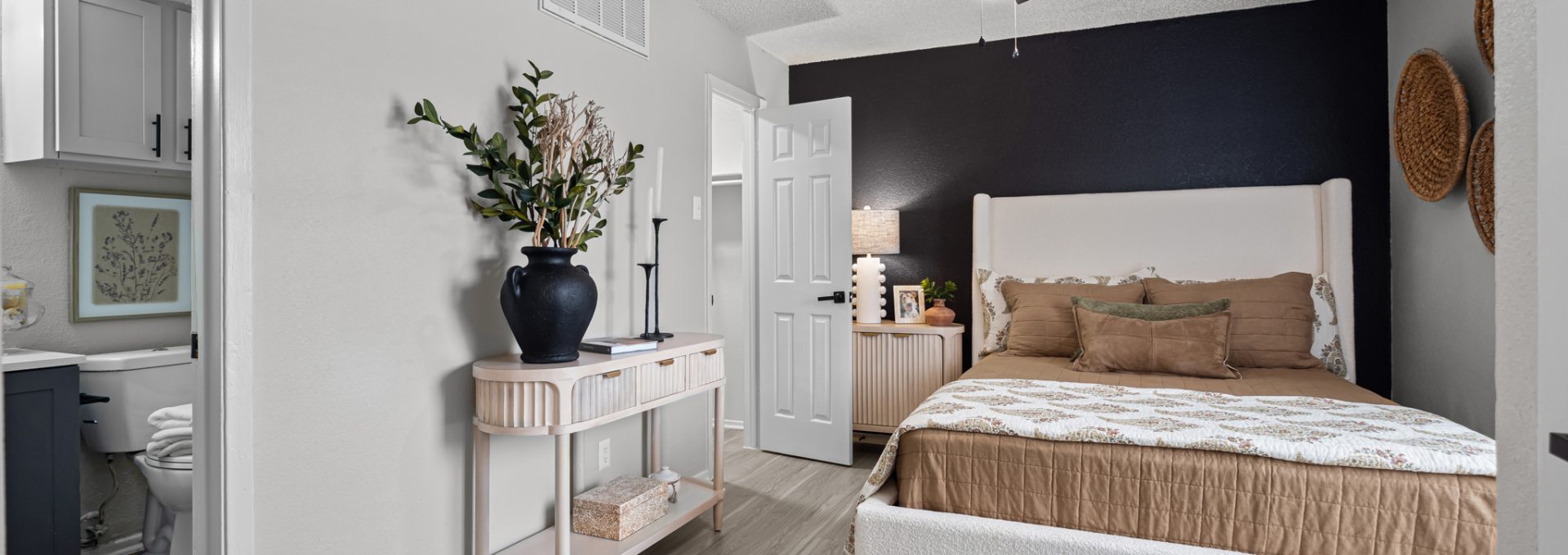 a bedroom with a ceiling fan and hardwood floors at The  Dahlia