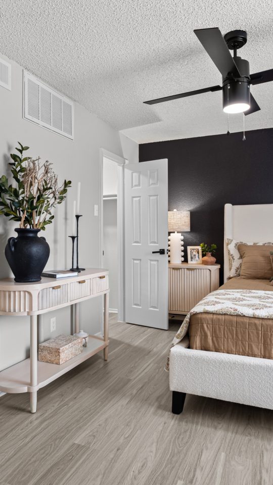 a bedroom with a ceiling fan and hardwood floors at The  Dahlia