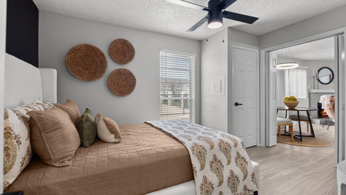 a bedroom with a ceiling fan and a bed at The  Dahlia