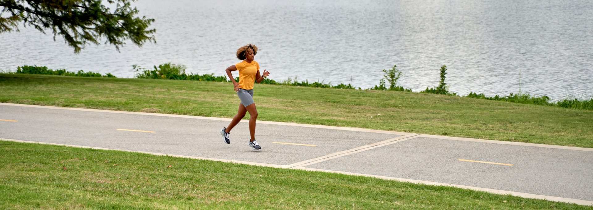 a person running on a path near a body of water